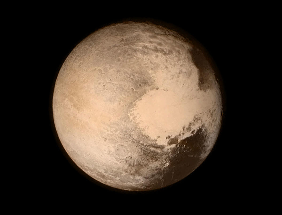 Pluto is enshrouded with haze particles that make the icy dwarf planet much colder than predicted. Reuters file photo.