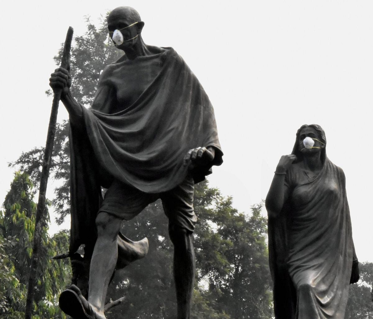 Anti-pollution masks on the statues of Gandhiji and his followers at Gyarah Murti in New Delhi. PTI FILE PHOTO