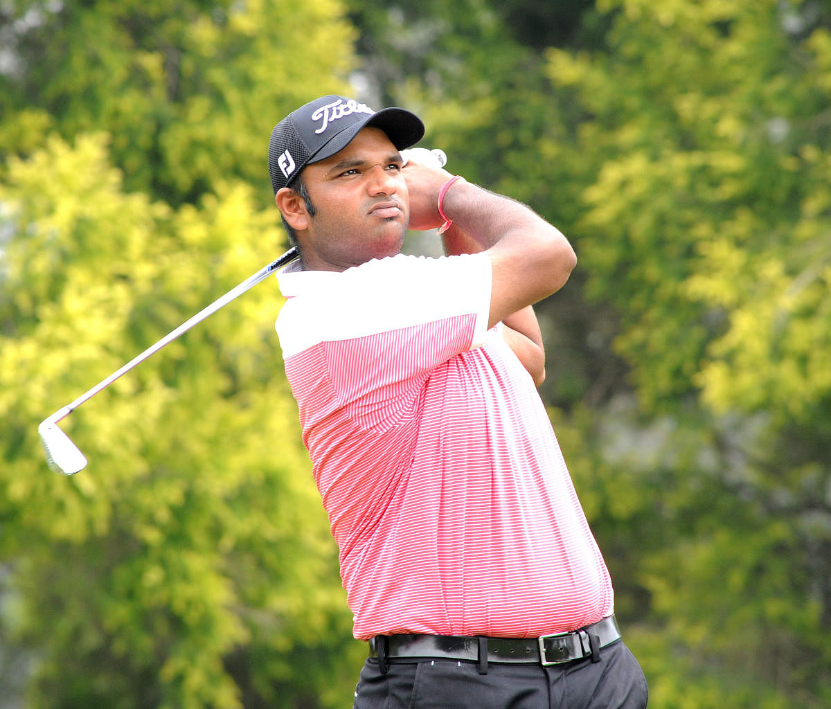 STEADY GOING Udayan Mane tees off during the third round of the Bengaluru Open at KGA on Friday. DH Photo/ Srikanta Sharma R