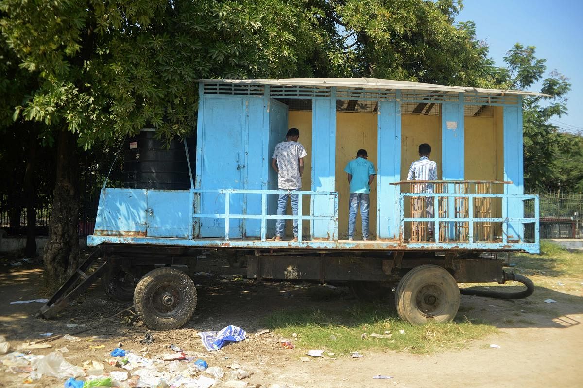 Youths using a mobile toilet facility at a park in Hyderabad. AFP FILE