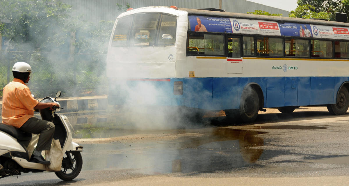 A BMTC bus (KA-01 F-3337) going with heavy smoke, polluting the air near Freedom Park in Bengaluru on Monday. -Photo/ Ranju P
