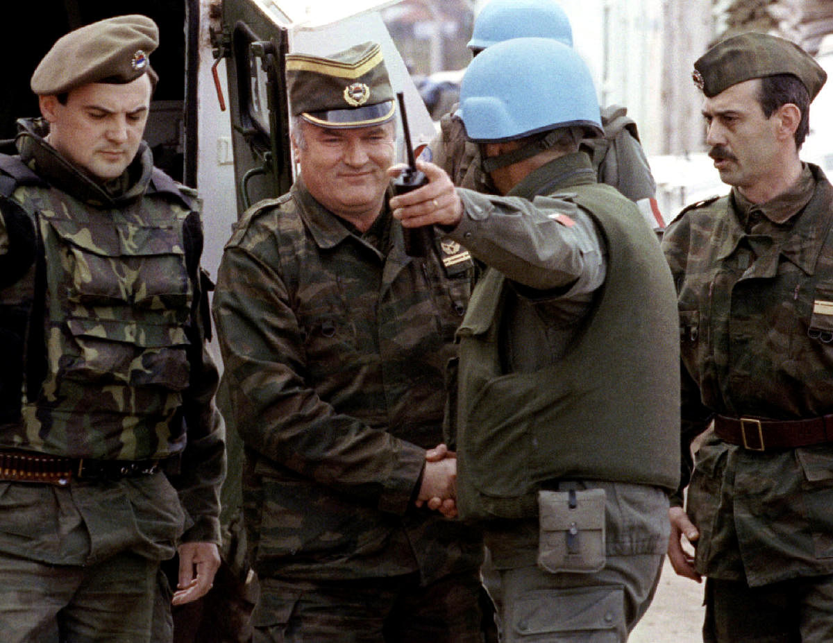 Bosnian Serb wartime general Ratko Mladic (2ndL) and a French Foreign Legion officer on his arrival at a failed UN-sponsored meeting in Sarajevo, Bosnia and Herzegovina, April 12, 1993. REUTERS