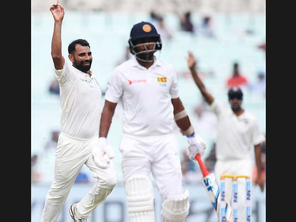 India's Mohammed Shami celebrates the wicket of Sri Lanka's Dilruwan Perera during the fourth day of the first Test between India and Sri Lanka at the Eden Gardens in Kolkata on Sunday.