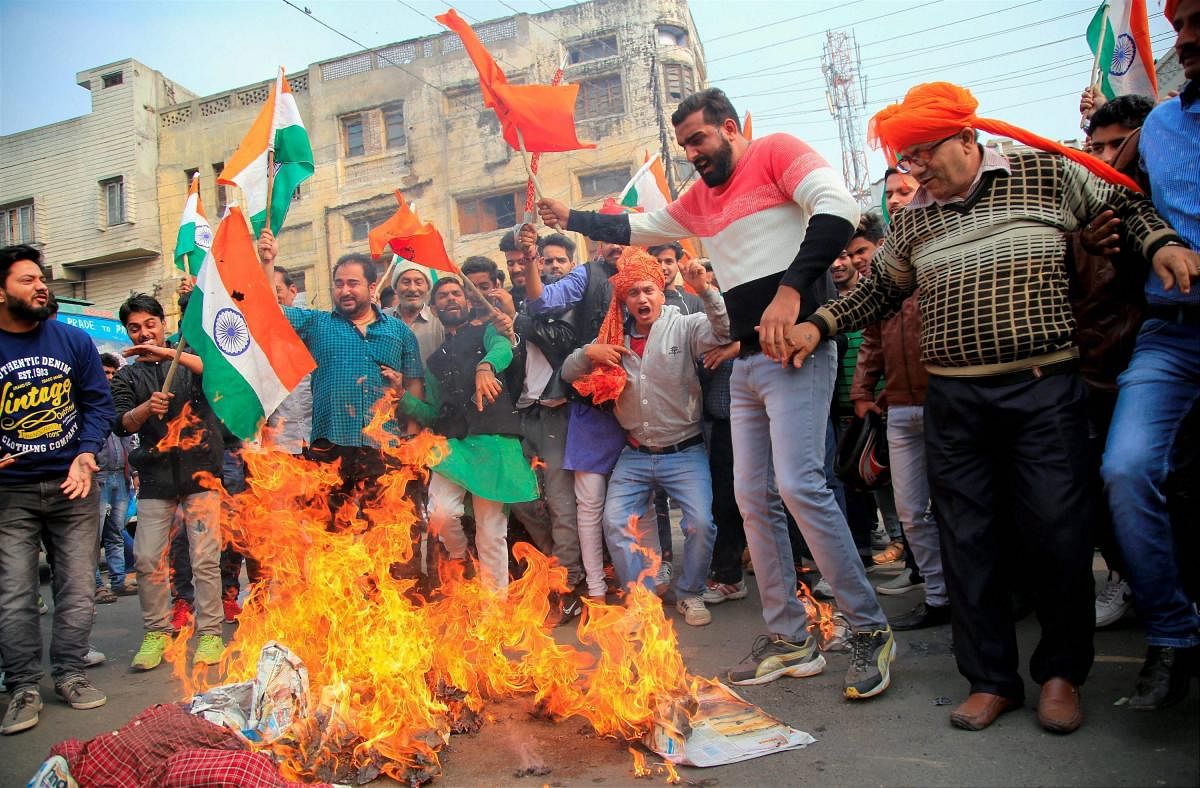 Jammu: Members of Rajput community protest and burn an effigy of film director against the release of controversial Bollywood movie Padmavati in Jammu on Saturday. PTI Photo (PTI11_18_2017_000122B)
