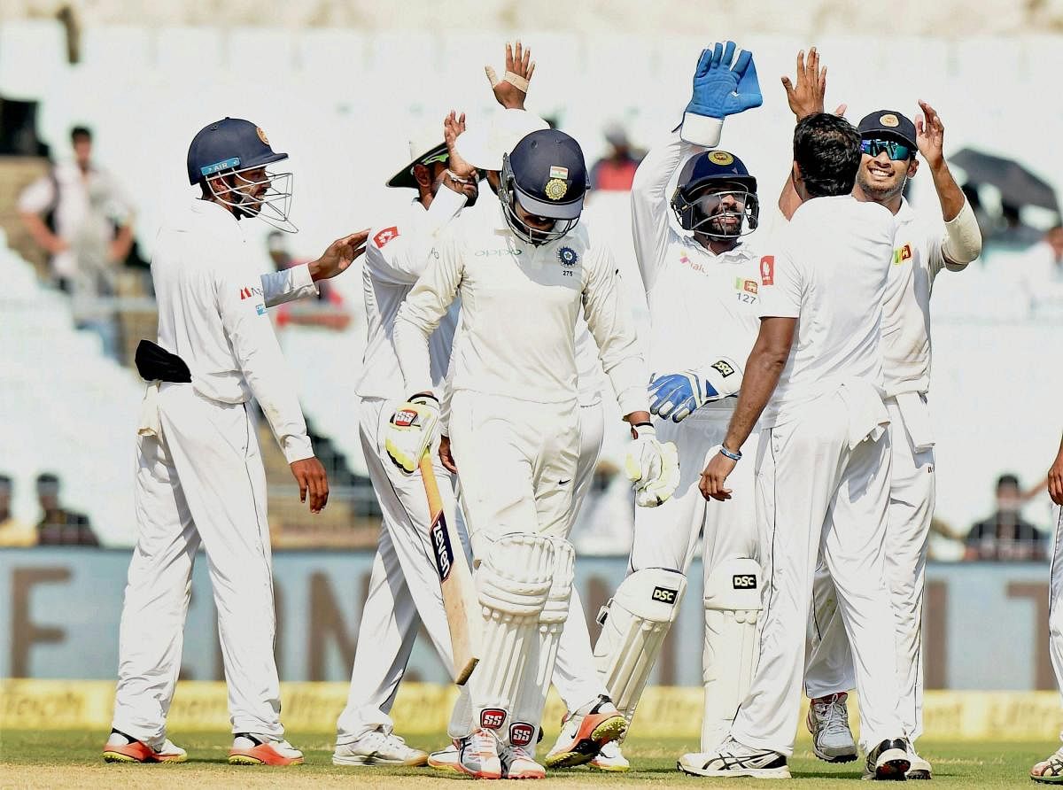 Sri Lankan players celebrate the dismissal of Indian batsman Ravindra Jadeja during the final day of the 1st cricket test match at Eden Gardens in Kolkata on Monday. PTI