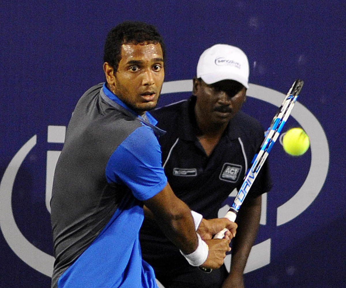 Ramkumar Ramanathan of India in action against Hugo Grenier of France in the mens singles in the 1st round of Bengaluru Open ATP Tennis Championship at KGA courts in Bengaluru on Tuesday. DH Photo/ Photo Srikanta Sharma R
