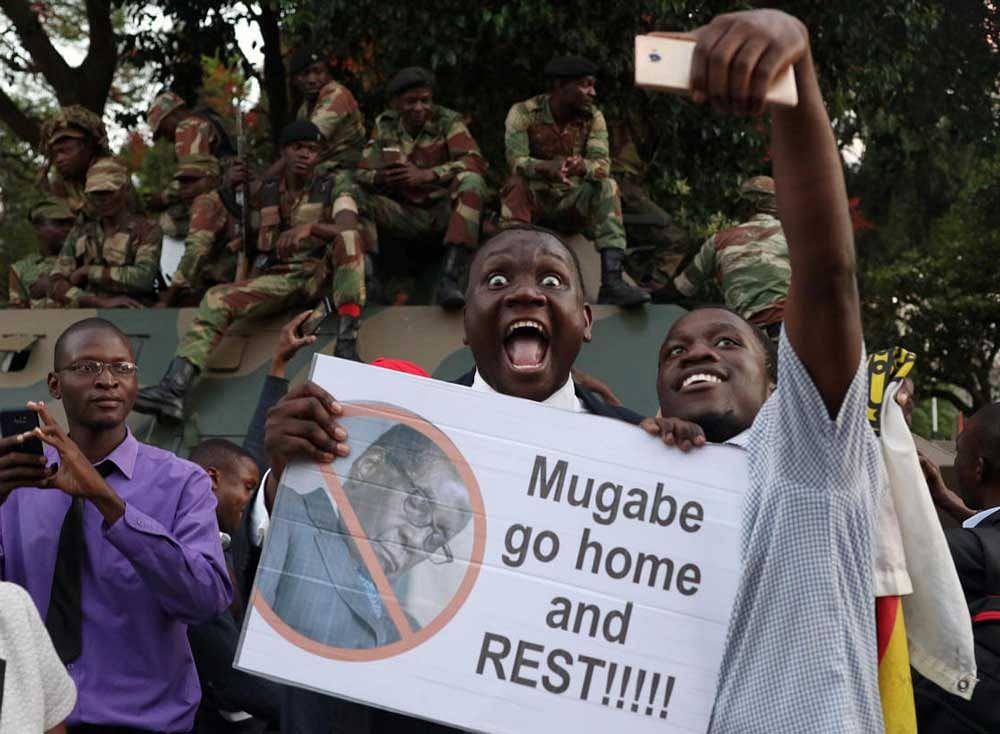 Zimbabweans celebrate after President Robert Mugabe resigns in Harare, Zimbabwe November 21, 2017. REUTERS