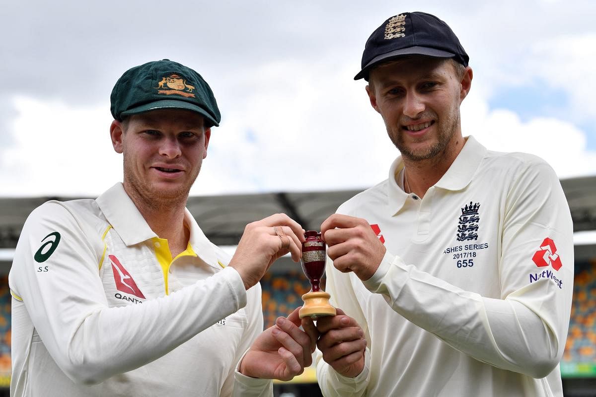 Australia's skipper Steve Smith (left) his counterpart Joe Root of England pose with the Ashes Urn on the eve of the opening Test at Gaba on Wednesday. Reuters
