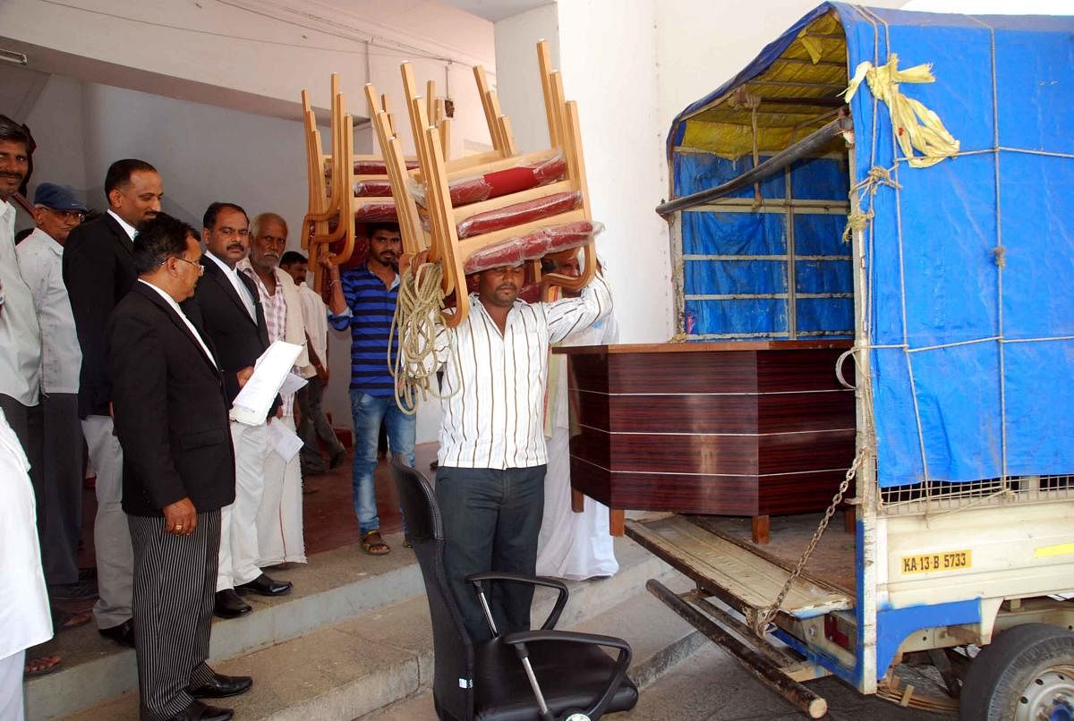 The furniture of the Special Land Acquisition Office being attached for the delay in providing compensation for the lands acquired for Yagachi canal works in Hassan on Wednesday.