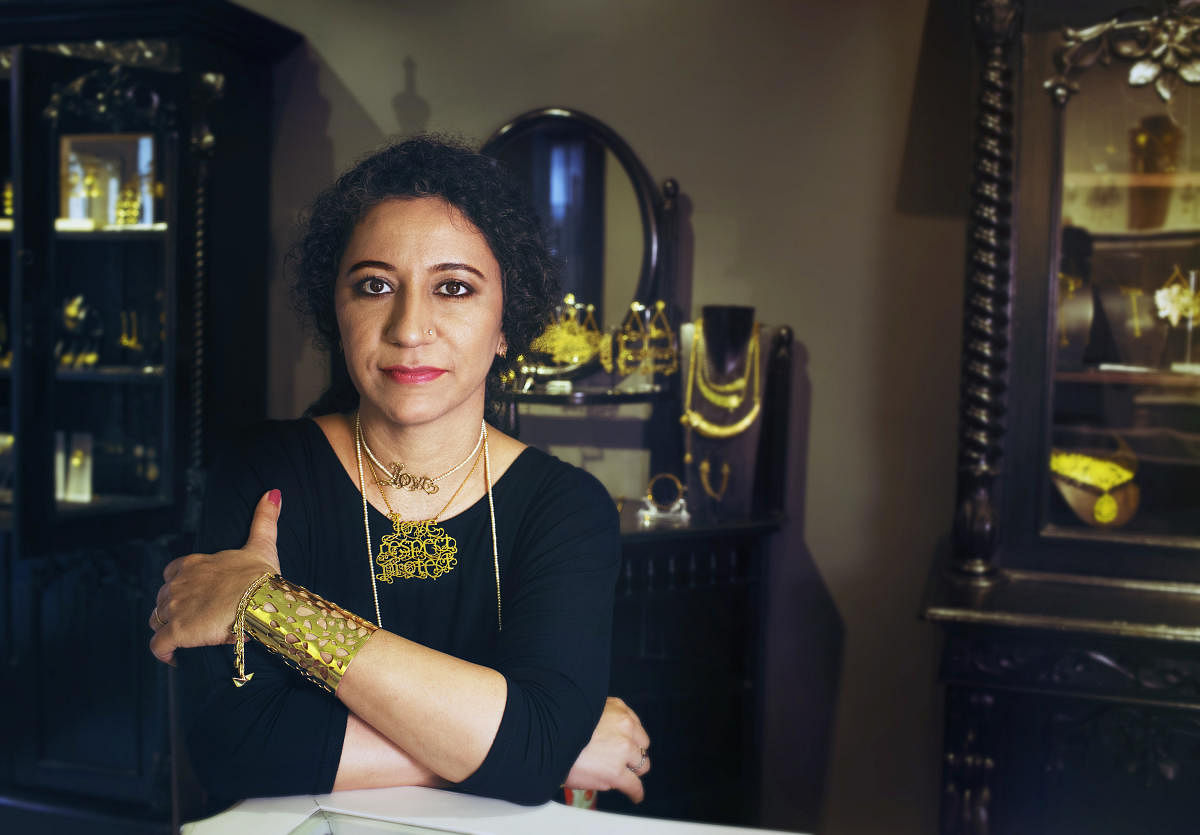 Eina Ahluwalia, a jeweler based in Kolkata, India, poses for a portrait on July 25, 2017. She is wearing a necklace that says