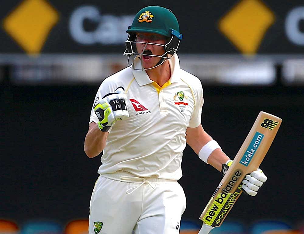 Australia's captain Steve Smith celebrates after reaching his century during the third day of the first Ashes cricket test match. REUTERS