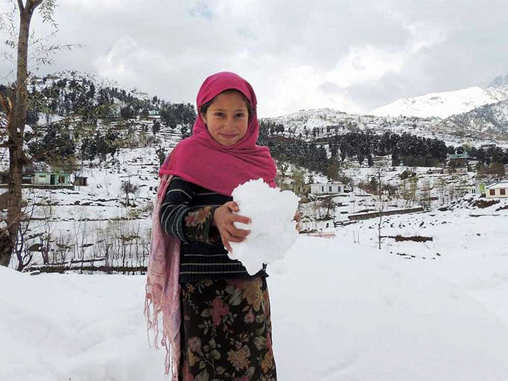 A girl enjoys snow after fresh snowfall in Bafliaz Dera-Ki-Gali in Pir Panchal in Poonch District of Jammu and Kashmir. PTI Photo