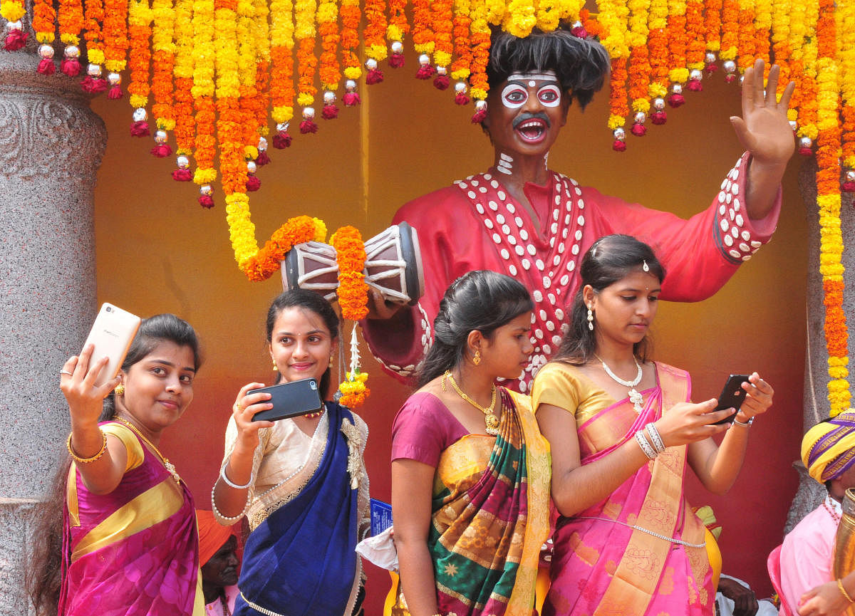 Young women take selfies during the 83rd Kannada Sahithya Sammelana, at Maharaja College Grounds in Mysuru on Friday.