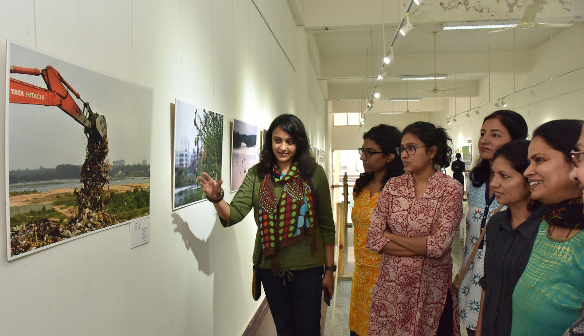 Photographer, writer and artist Arati Kumar Rao giving a rundown on her work at the exhibition on Friday. DH Photo by Janardhan B K