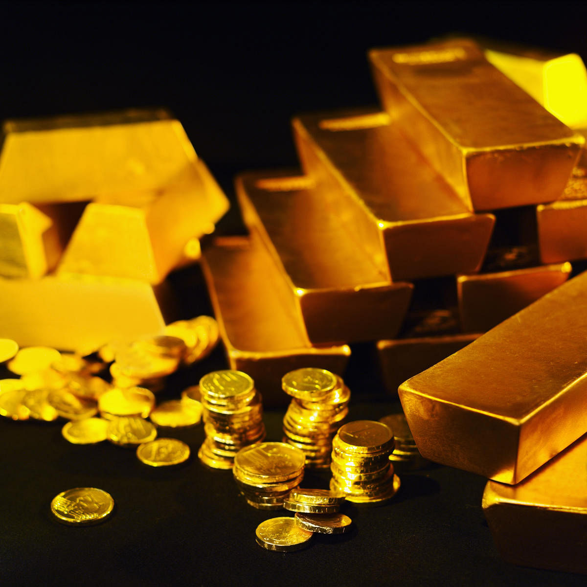 Close-up of gold bars and stacks of one euro coinsgold