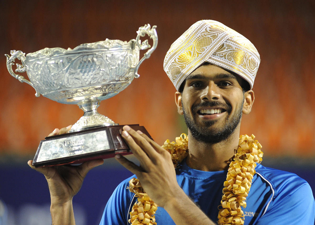 PICTURE PERFECT Sumit Nagal is all smiles after emerging triumphant in the Bengaluru Open. DH PHOTO/ SRIKANTA SHARMA R