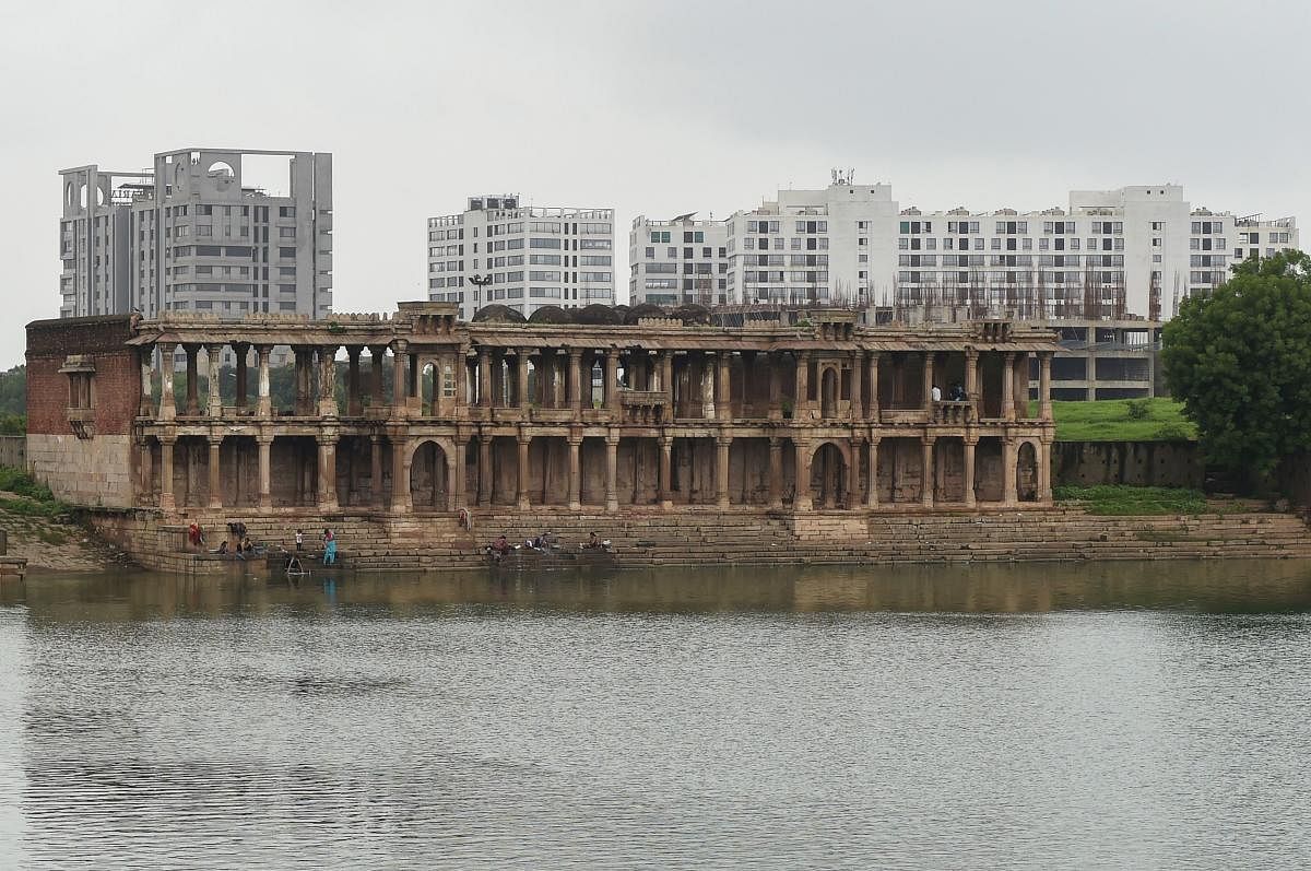 This picture taken on July 31, 2017 shows the ruins of the 15th century 'Tombs of the Queens' building at the Sarkhej Roza complex in Ahmedabad. The crumbling, 600-year-old mosques, traditional markets and ornate homes of Ahmedabad have been named India's first UNESCO city, despite objections from heritage experts. But Ahmedabad is one of the world's most polluted cities and despite the fanfare, the old city is decaying under neglect, traffic and trash as the pressures of modern India tarnish its historic legacy. / AFP PHOTO / SAM PANTHAKY / To go with: 'India-culture-conservation-UNESCO,FEATURE' by Nick PERRY