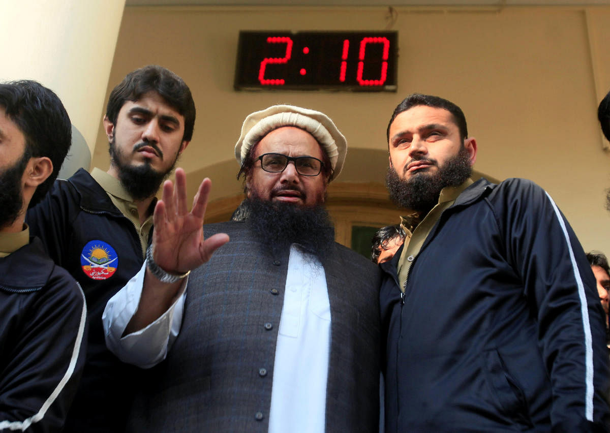 Hafiz Saeed speaks with supporters after attending Friday Prayers in Lahore, Pakistan November 24, 2017. REUTERS/Mohsin Raza