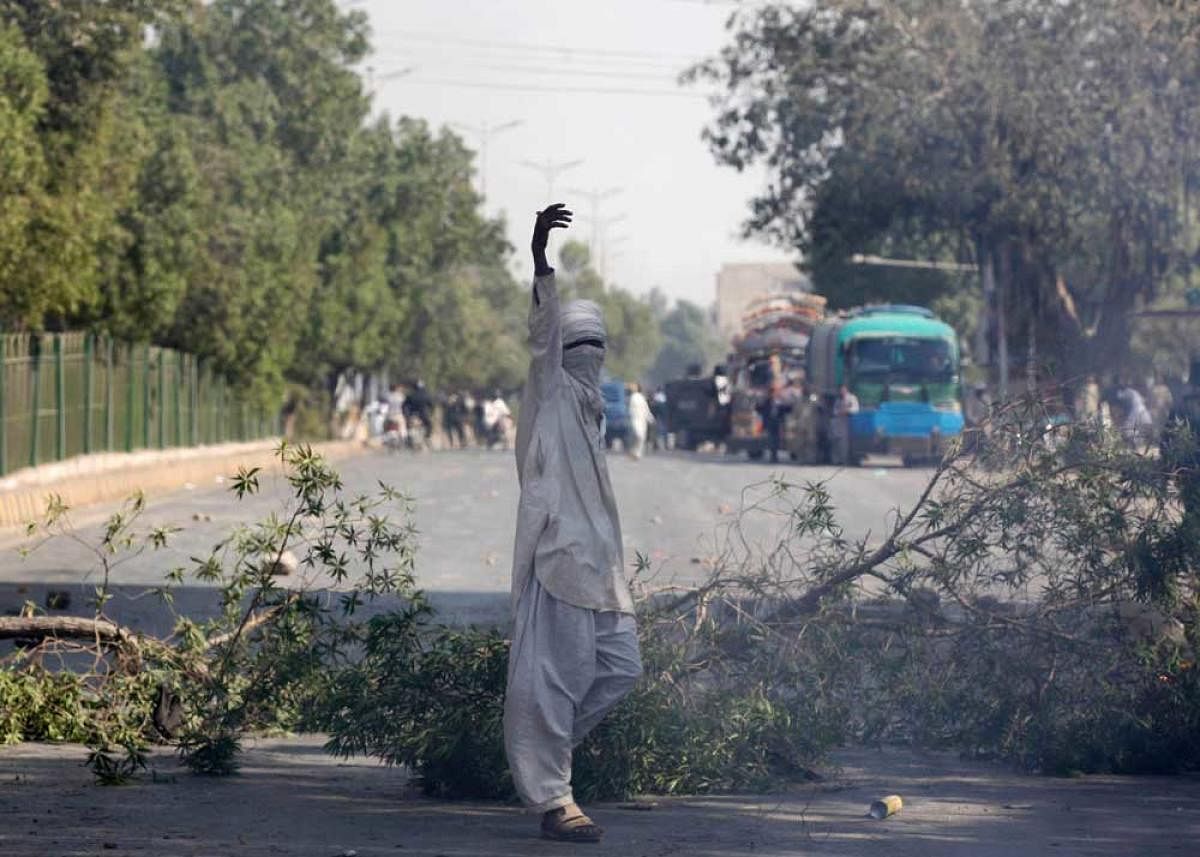 A supporter of the Tehreek-e-Labaik Pakistan, an Islamist political party, gestures after blocking the main road leading to the airport in Karachi. Reuters file photo.