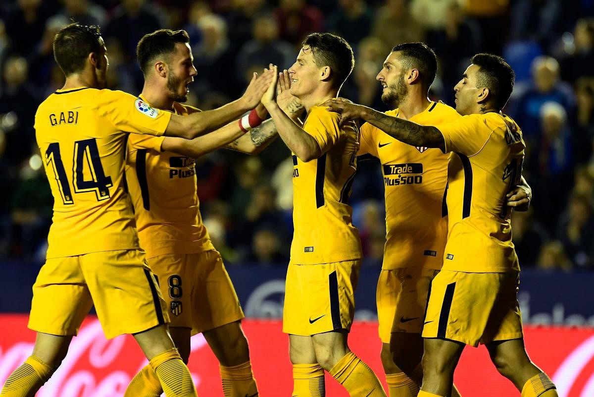 Atletico Madrid's Kevin Gameiro (centre) celebrate with team-mates after scoring against Levante UD. AFP