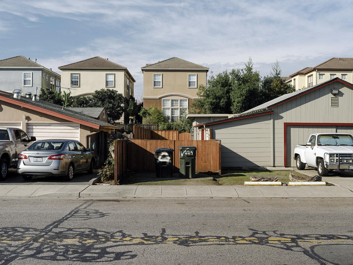 New housing developments tower over older homes along Pulgas Avenue in East Palo Alto, Calif., Nov. 22, 2017. The city evicted residents living in recreational vehicles to clear the way for a school funded by the Chan Zuckerberg Initiative, a limited liability company set up by Facebook's co-founder Mark Zuckerberg and his wife, Priscilla Chan. (Jason Henry/The New York Times)