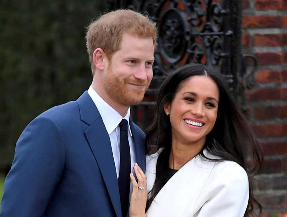 Britain's Prince Harry poses with Meghan Markle in the Sunken Garden of Kensington Palace, London. Reuters.