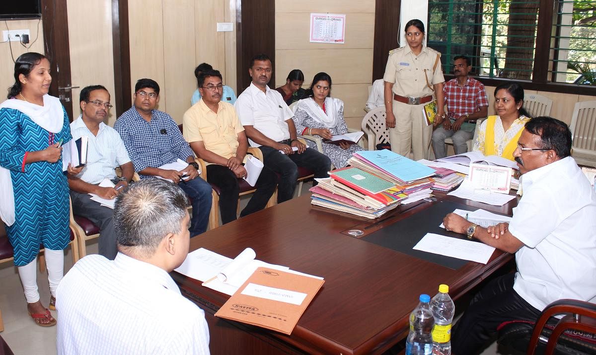 Excise Minister R B Timmapur (right) holds meeting with the Excise Department staff at the department's office at Navanagar in Hubballi on Tuesday.