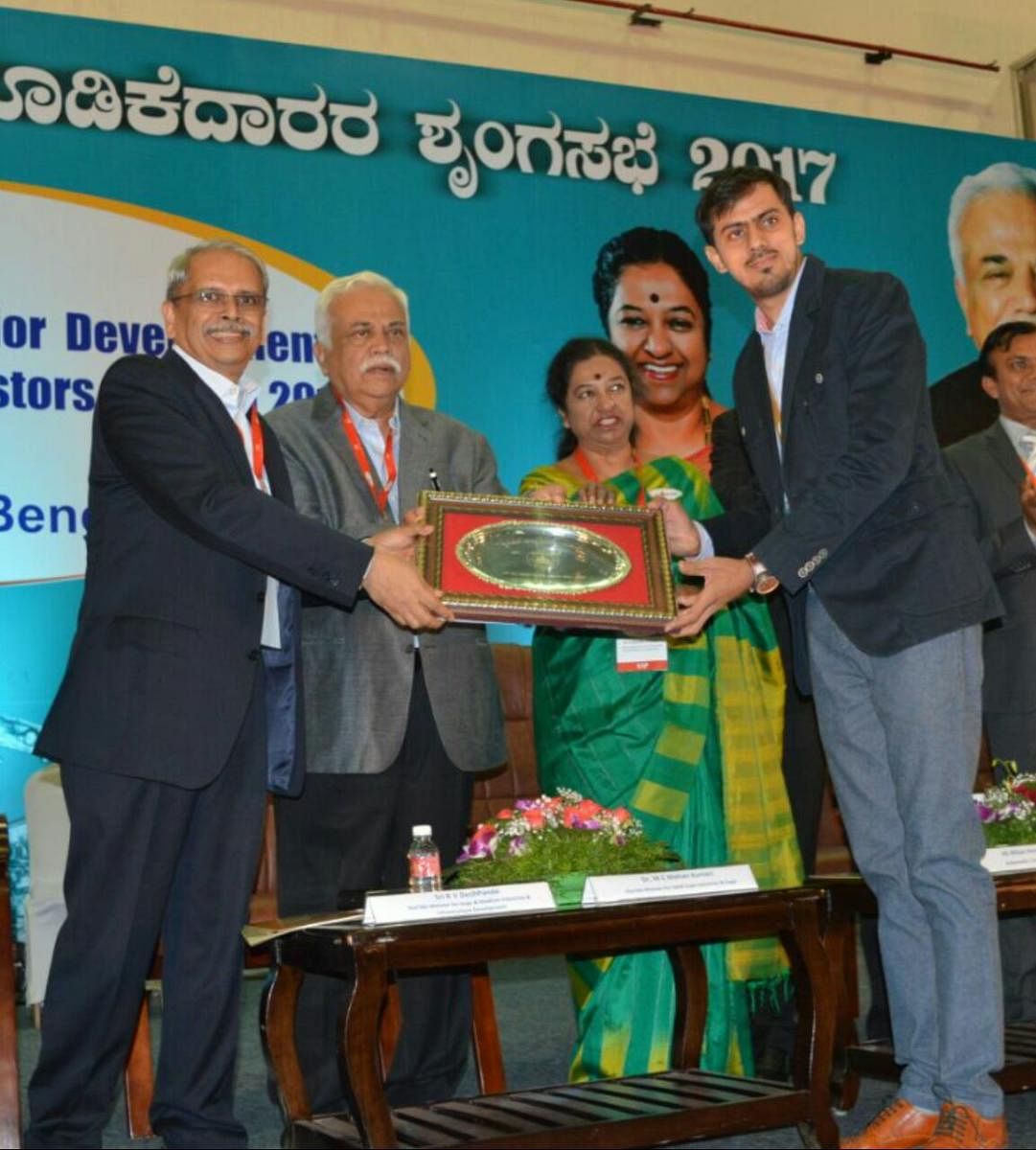 Hubballi-based Krishna Engineering Company proprietor Kartik Thakkar receives Sir M Visvesvaraya Manufacturing Excellence Award at the Invest Karnataka Summit held in Bengaluru. Ministers R V Deshpande, and M C Mohankumari are present.