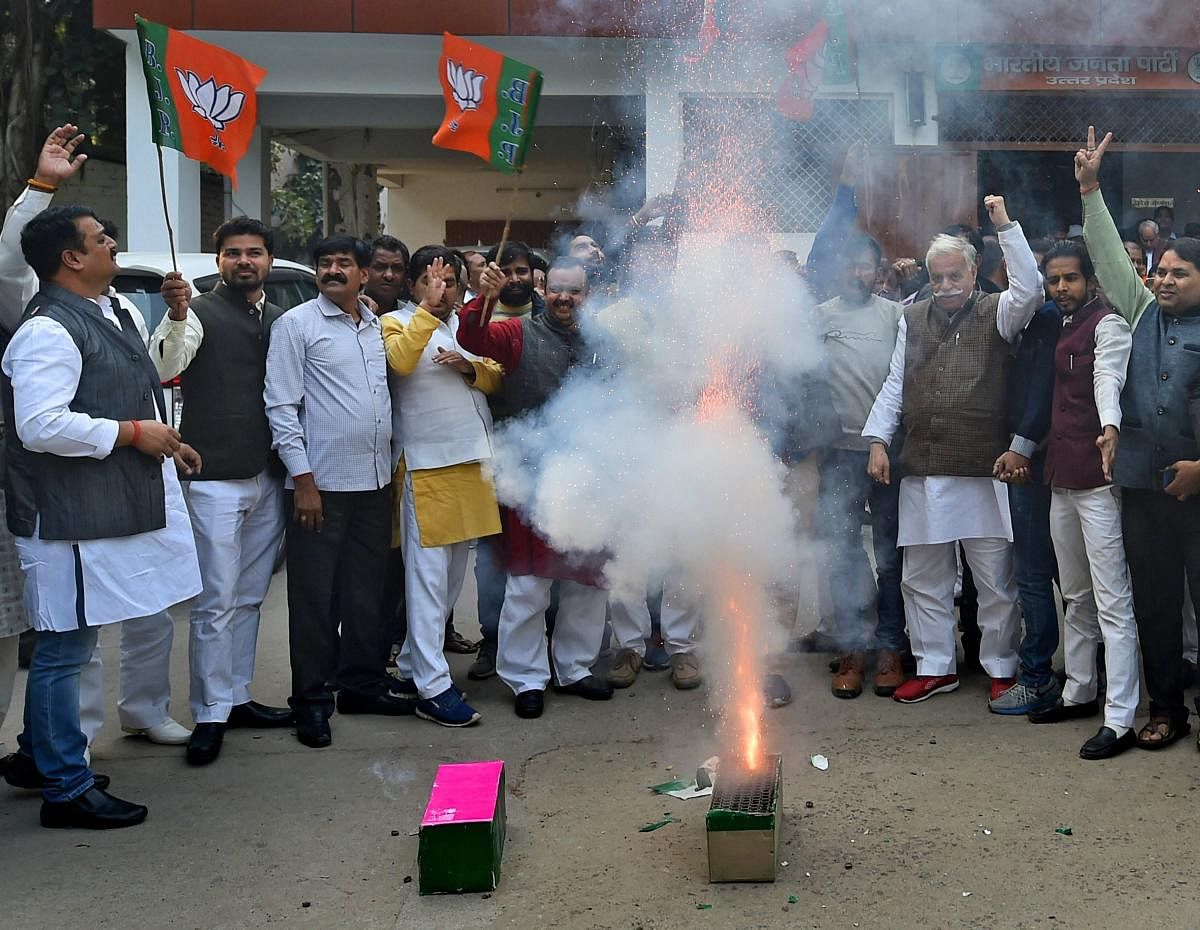 BJP workers celebrating the victory of the party in the civic body elections at the party office in Lucknow on Friday. PTI Photo