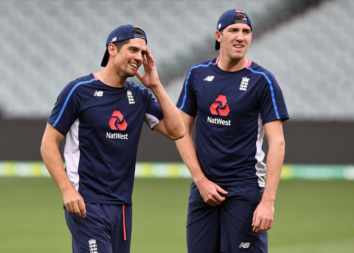 England players Alastair Cook (left) and Craig Overton share a light moment during the training at the Adelaide Oval. AFP