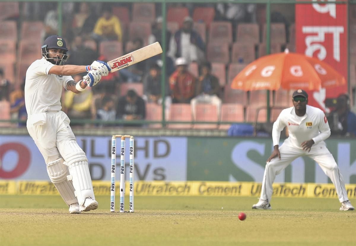 Indian skipper Virat Kohli plays a shot against Sri Lanka during the first day of the third cricket test match at Feroz Shah Kotla, in New Delhi on Saturday. PTI