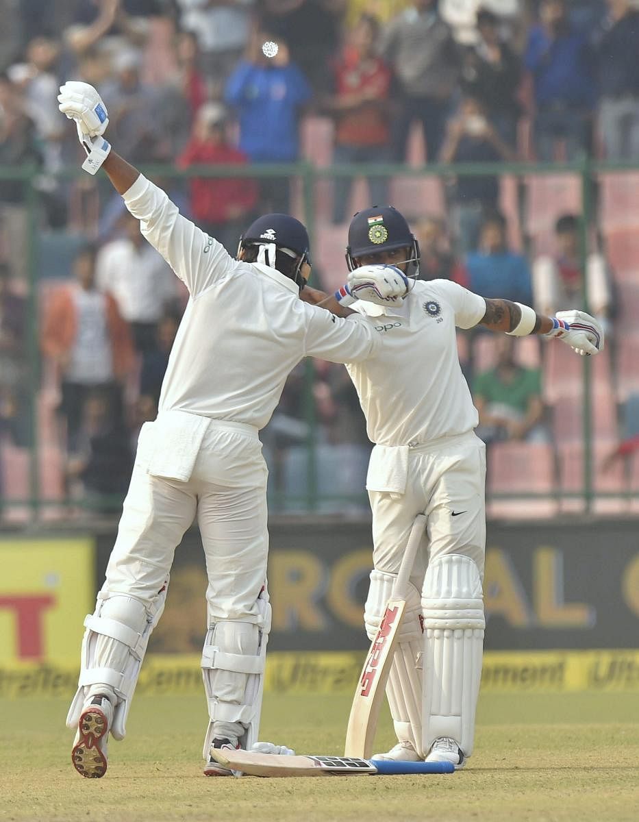 New Delhi: Indian cricketer Murali Vijay celebrates with skipper Virat Kohli after completing his century against Sri Lanka during the first day of the third cricket test match at Feroz Shah Kotla, in New Delhi on Saturday. PTI Photo by Atul Yadav(PTI12_2_2017_000058B)