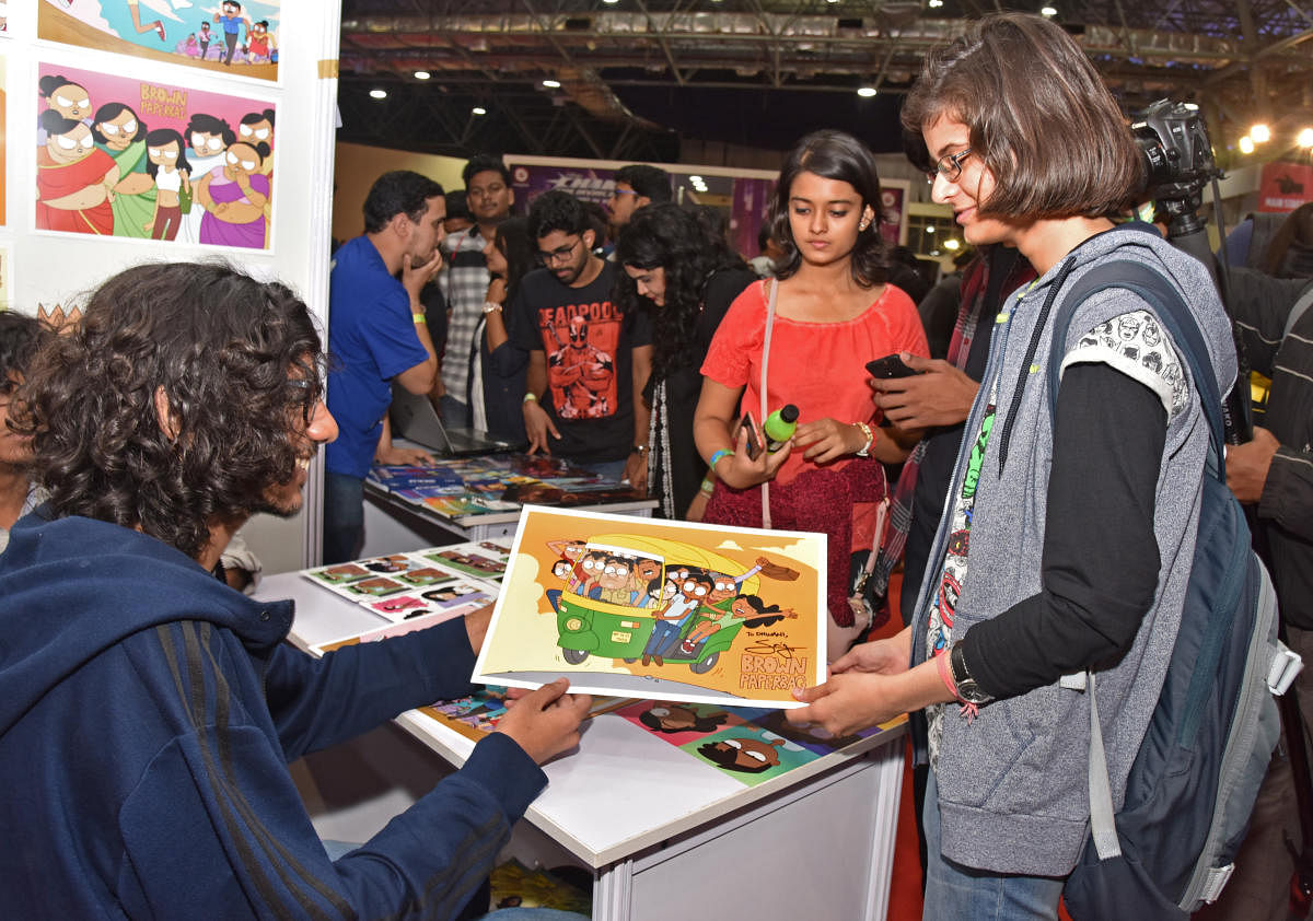 Sailesh Gopalan, creator of Brown Papebag giving autograph to people at Bengaluru Comic Con organised by Comic Con India at KTPO Convention Centre, Whitefield in Bengaluru on Saturday. Photo by S K Dinesh