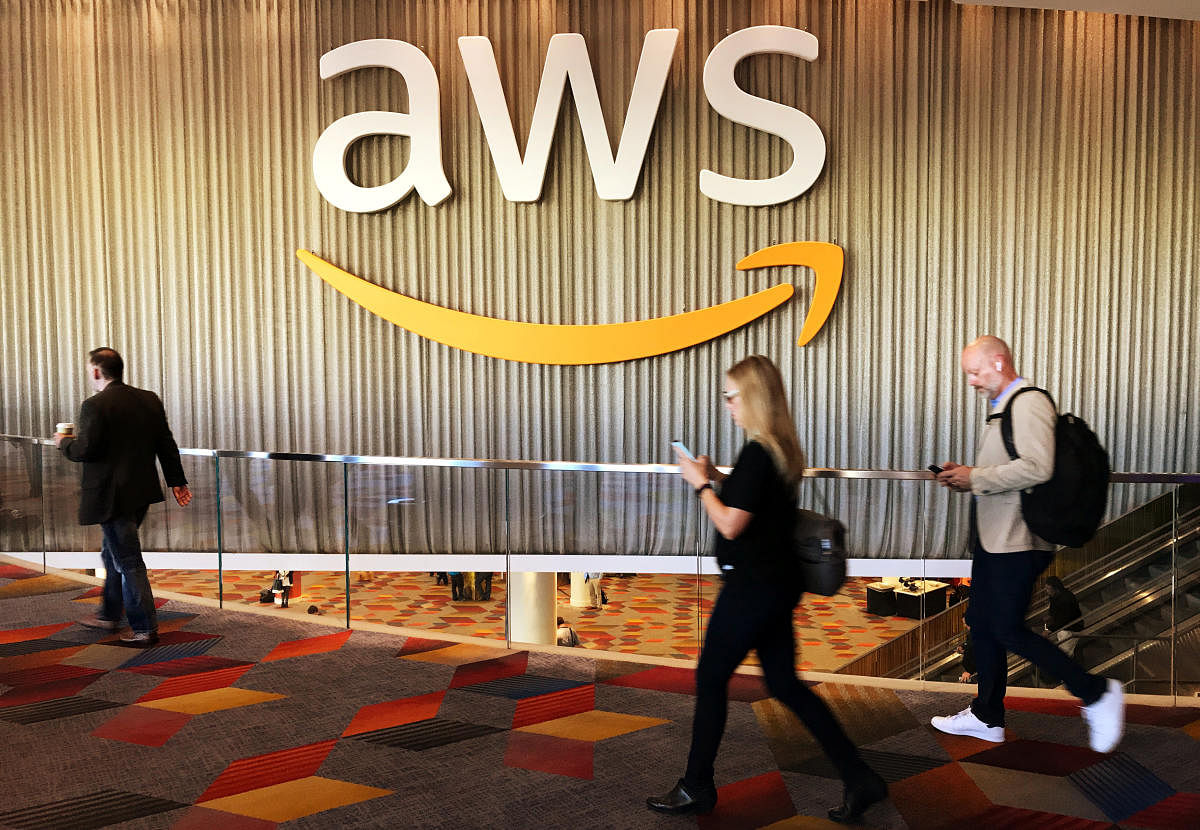 Attendees at Amazon.com Inc annual cloud computing conference walk past the Amazon Web Services logo in Las Vegas, Nevada, U.S., November 30, 2017. REUTERS/Salvador Rodriguez