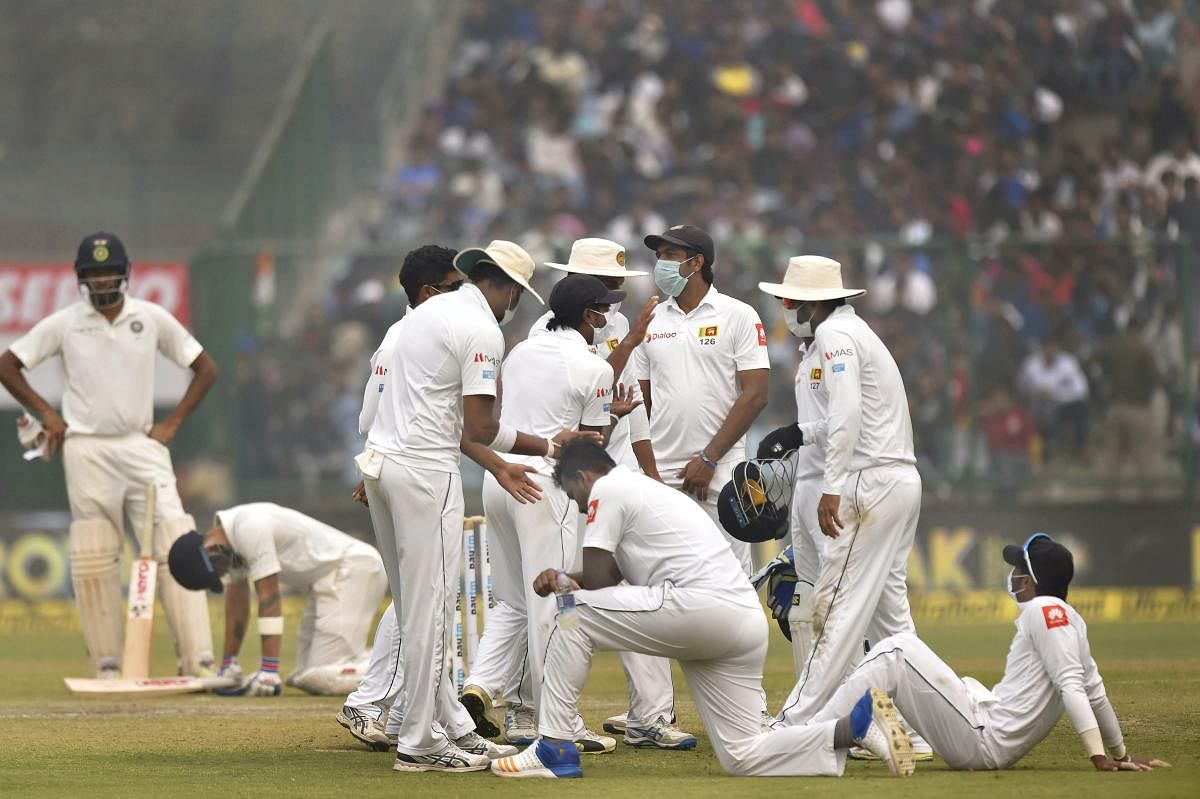 New Delhi: Sri Lankan players wear anti-pollution masks on the field, as the air quality deteriorates during the second day of their third test cricket match against India in New Delhi on Sunday. PTI Photo by Atul Yadav