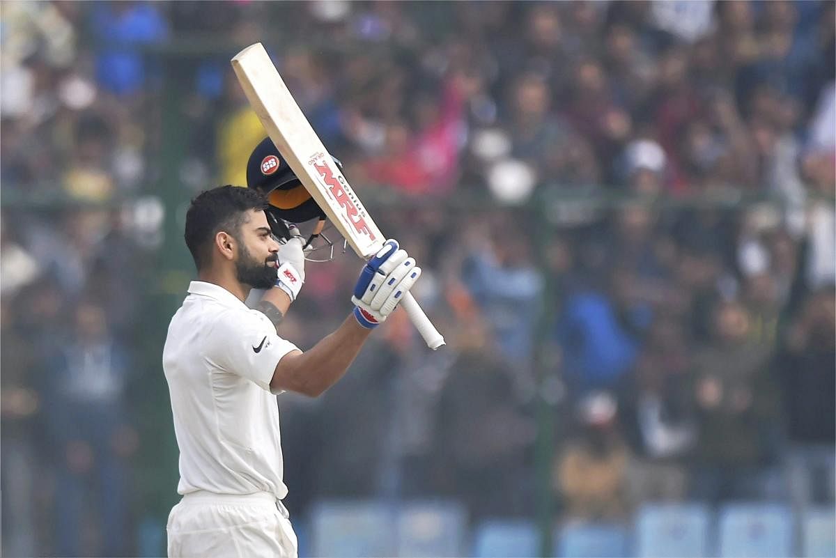 India's Virat Kohli acknowledges the crowd as he celebrates his double century against Sri Lanka during the second day of the third cricket test match at Feroz Shah Kotla, in New Delhi on Sunday. (PTI Photo by Atul Yadav)