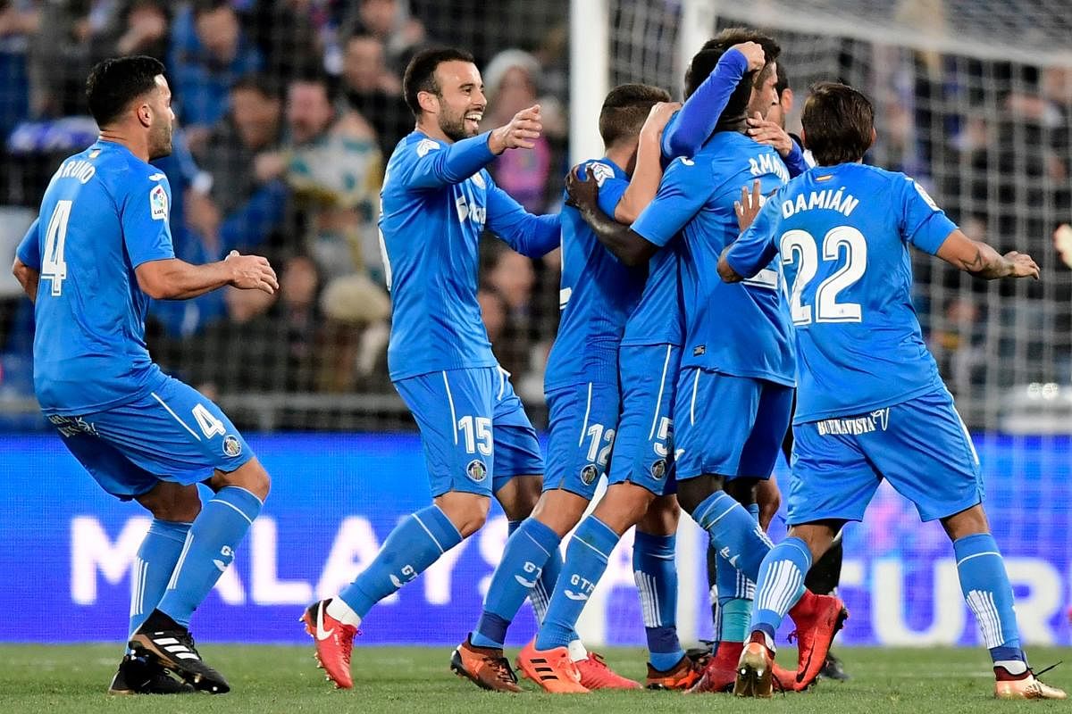 Getafe players celebrate after scoring a goal against Valencia at the Col Alfonso Perez stadium in Getafe on Sunday. AFP