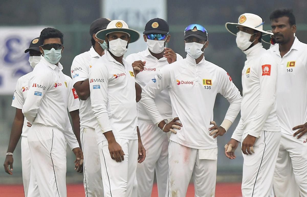 Sri Lankan players wear anti-pollution masks on the field, as the air quality deteriorates during the second day of their third test cricket match against India in New Delhi on Sunday. PTI