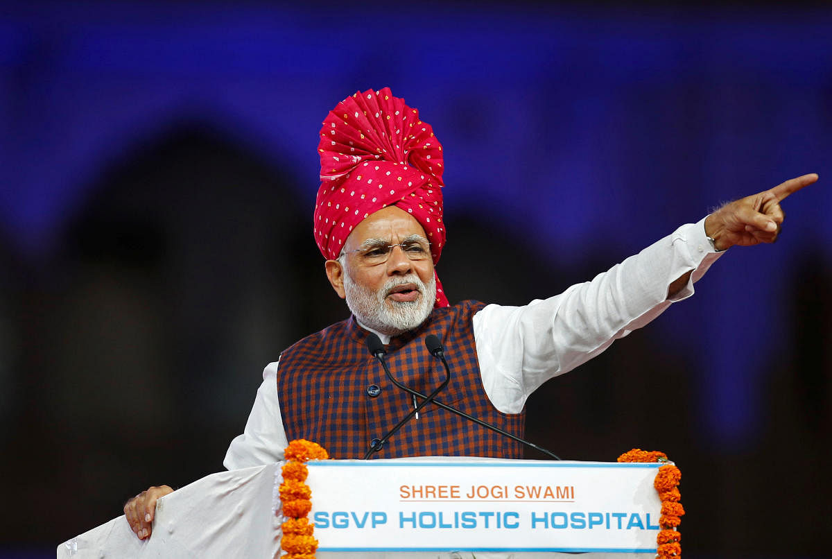 Narendra Modi gestures as he addresses his supporters during an election campaign meeting ahead of Gujarat state assembly elections, in Ahmedabad. REUTERS