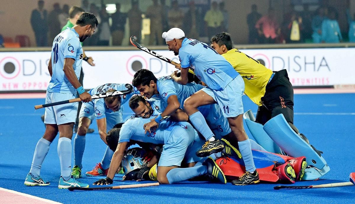 Indian players celebrate with goalkeeper Akash Chikte after defeating Belgium in the Hockey World League Final on Wednesday. India posted a 3-2 win in sudden-death to enter the semifinals. PTI