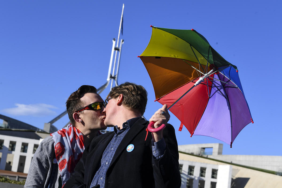 A couple kisses outside Parliament House during an equality rally in Canberra December 7, 2017. Reuters