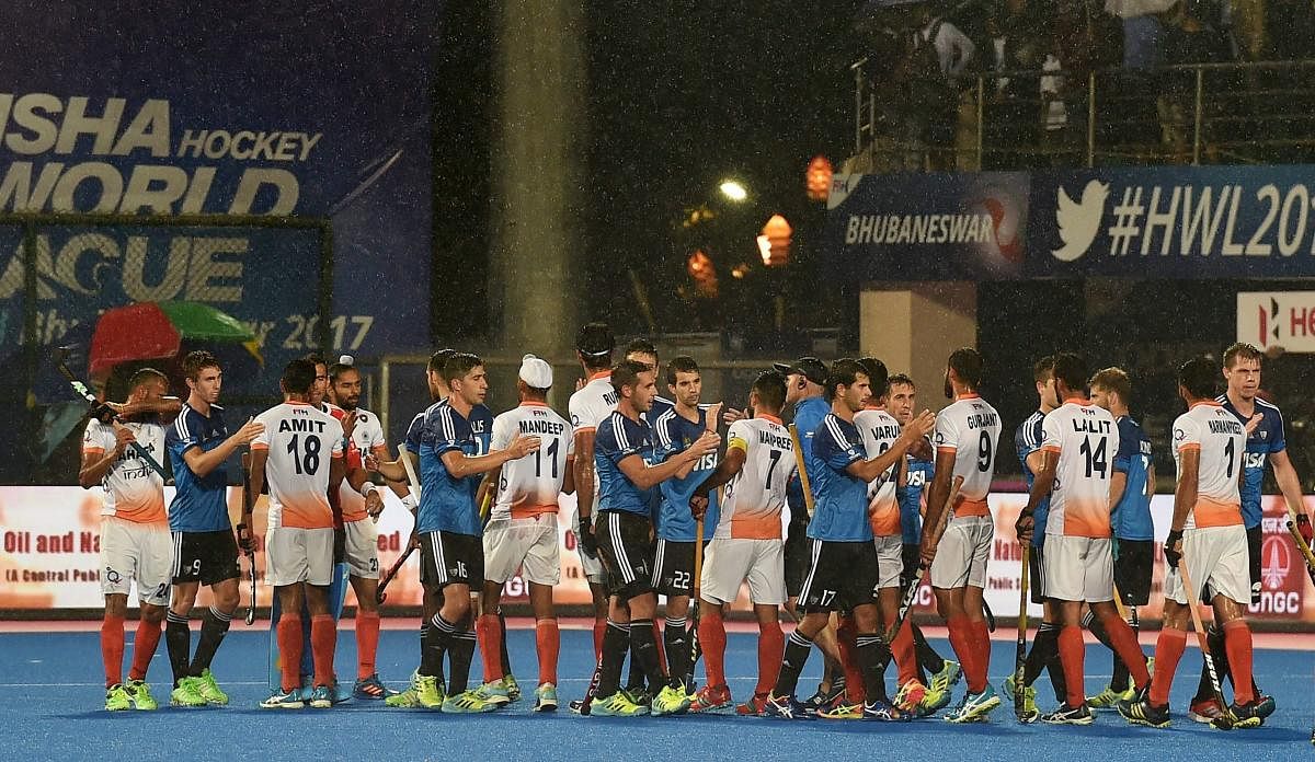 India and Argentina players exchange greetings at the end of 1st semifinal match during Men's Hockey World League final at Kalinga Stadium in Bhubaneswar on Friday evening.A rgentina won the match by 1-0 and enter in the final. PTI Photo by Swapan Mahapatra
