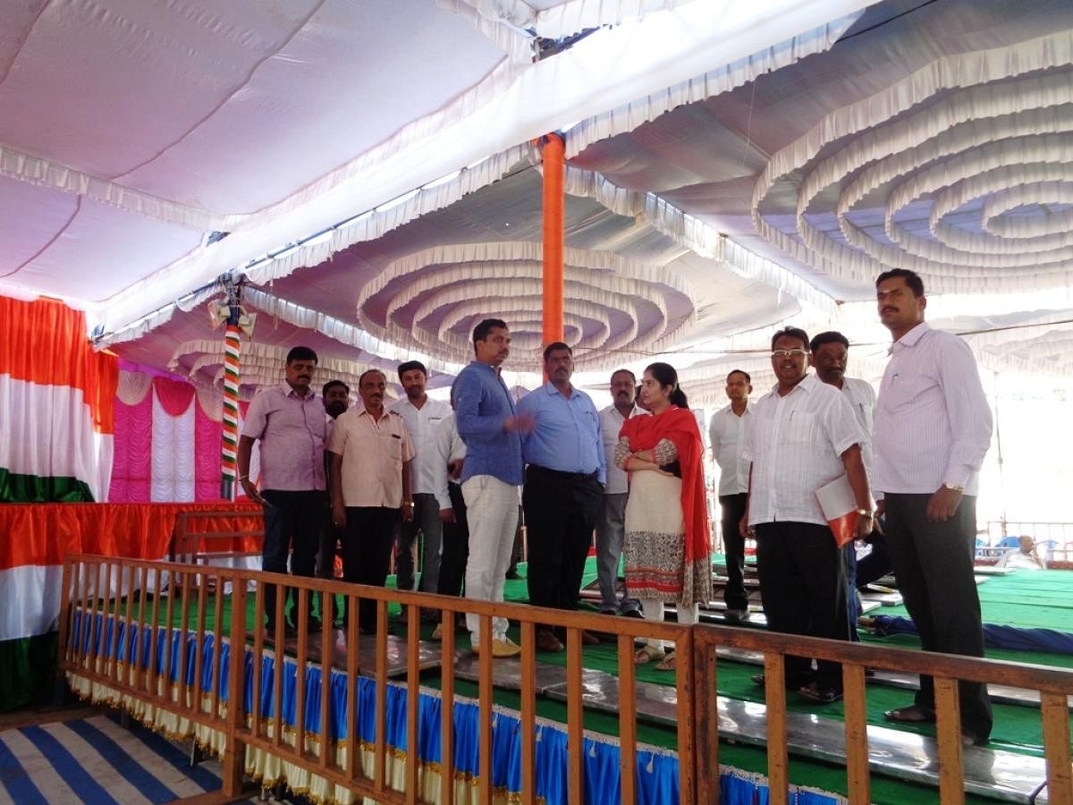 Deputy Commissioner C Anitha inspects the preparations made for a mass marriage at Rajiv Gandhi Stadium in Madhugiri on Saturday. State Youth Congress vice president R Rajendra, Assistant Commissioner Dr Venkateshaiah and Tahsildar H Srinivas look on.