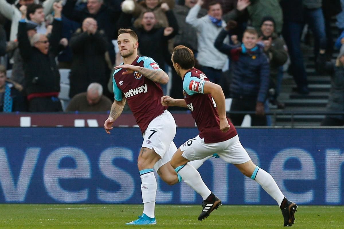 West Ham United's Austrian midfielder Marko Arnautovic (L) celebrates with West Ham United's English midfielder Mark Noble after scoring the opening goal of the English Premier League football match between West Ham United and Chelsea at The London Stadium, in east London on December 9, 2017. / AFP PHOTO / Ian KINGTON / RESTRICTED TO EDITORIAL USE. No use with unauthorized audio, video, data, fixture lists, club/league logos or 'live' services. Online in-match use limited to 75 images, no video emulation. No use in betting, games or single club/league/player publications. /