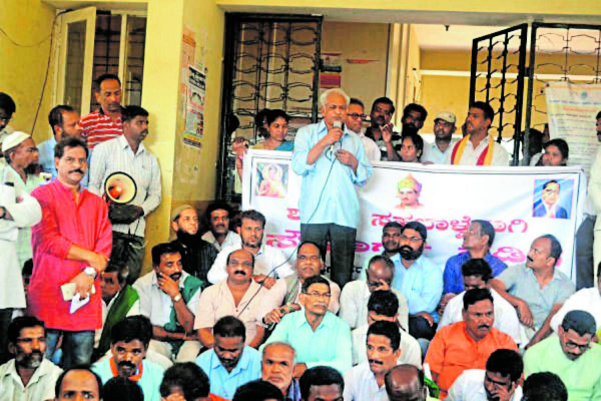 Writer K S Bhagwan addresses the participants of a peace march in Hunsur town on Monday.