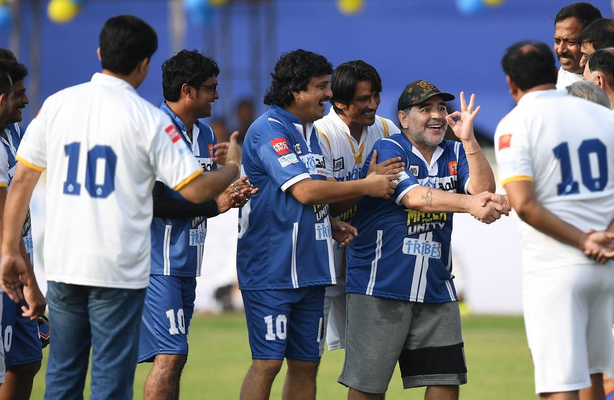 Diego Maradona (centre) enjoys his time with former Indian cricketer Sourav Ganguly and others on Tuesday. PTI