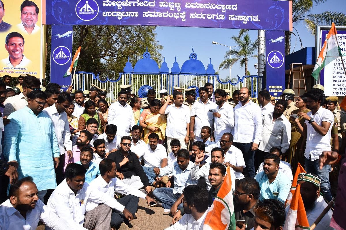 Congress Party workers stage protest in front of the airport entrance in Hubballi on Tuesday, during the inauguration of the upgraded airport.