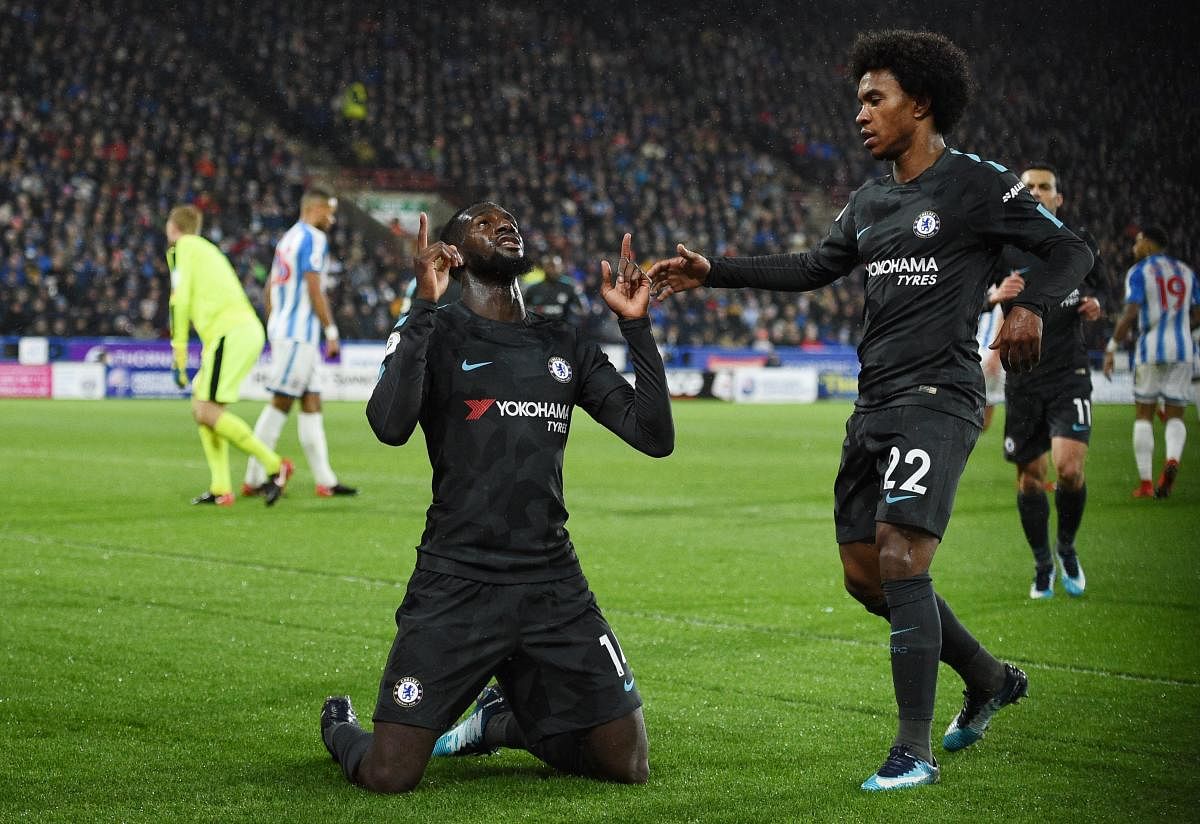 Chelsea's French midfielder Tiemoue Bakayoko (L) celebrates after scoring with Chelsea's Brazilian midfielder Willian during the English Premier League football match between Huddersfield Town and Chelsea at the John Smith's stadium in Huddersfield, northern England on December 12, 2017. / AFP PHOTO / Oli SCARFF / RESTRICTED TO EDITORIAL USE. No use with unauthorized audio, video, data, fixture lists, club/league logos or 'live' services. Online in-match use limited to 75 images, no video emulation. No use in betting, games or single club/league/player publications. /