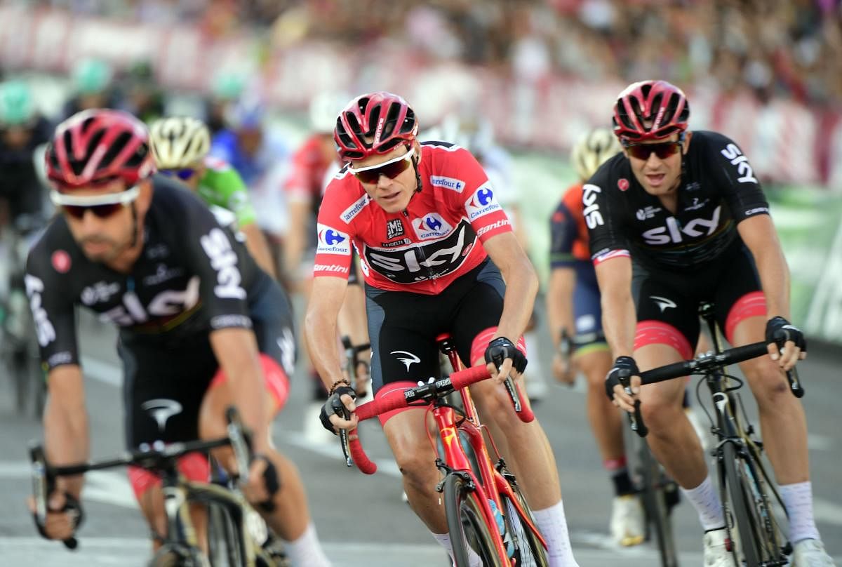 Chris Froome (centre) riding in Madrid during the 21st and last stage of the 72nd edition of