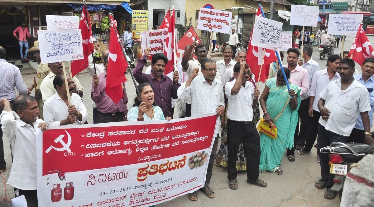 CITU members stage a protest against hike in price of LPG and essential commodities in front of the post office in Udupi on Wednesday.